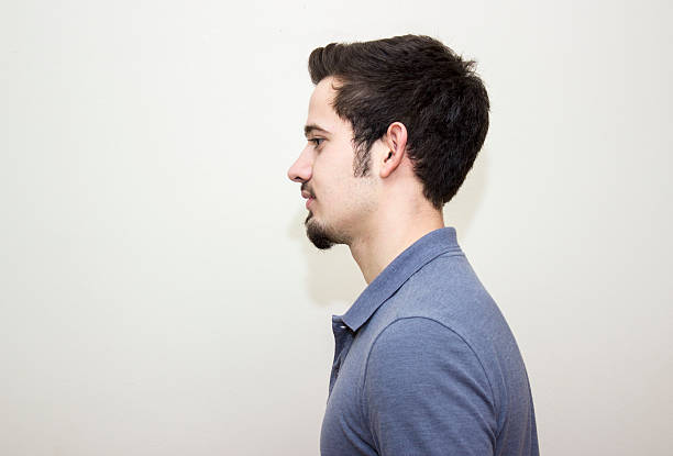 istock Profile view of young man over colored background 512819336