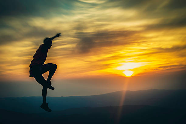 istock Silhouette of hiker jumping in sundown 512820416