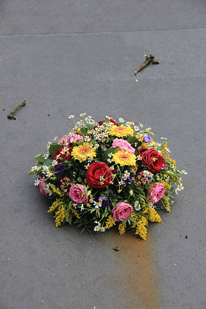 istock Sympathy flowers on a tombstone 512824082