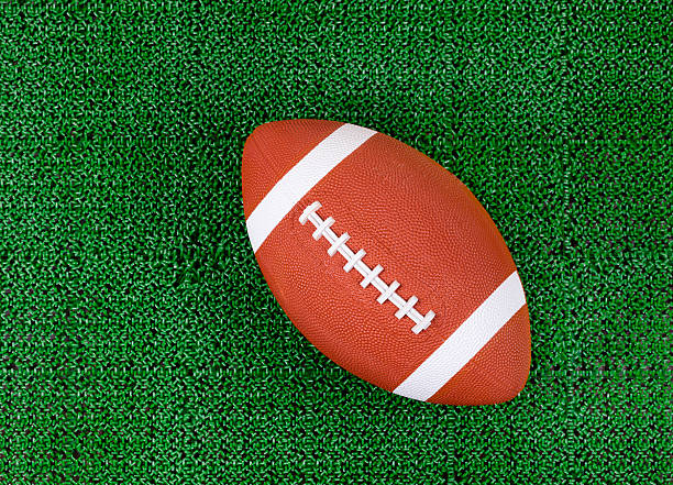 istock American football on artificial green grass turf field 512824502