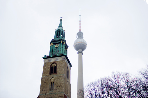 Berlin TV tower with St. Mary's Church in foggy day