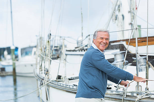 istock Senior man at marina, standing next to his yacht 512825286