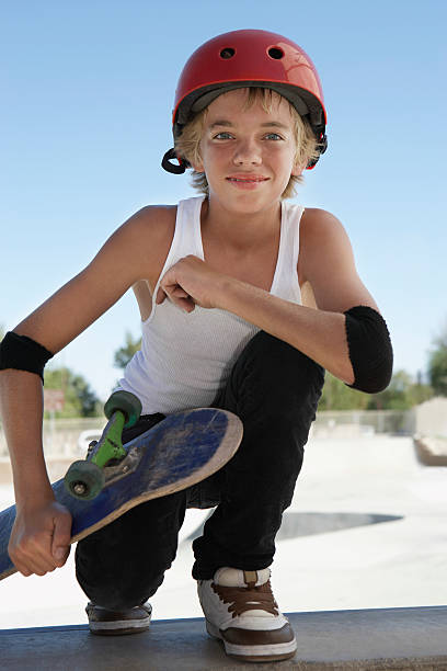 istock Boy With Skateboard Squatting In Skate Park 512834931