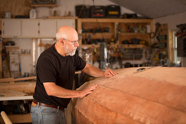 Man working in his shop to build a boat
