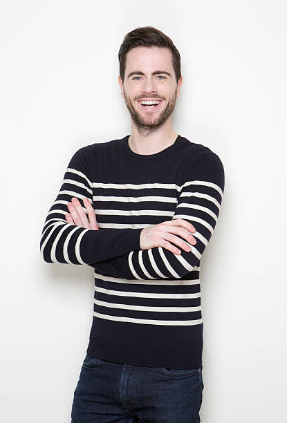 istock Young man smiling with arms crossed 512859819