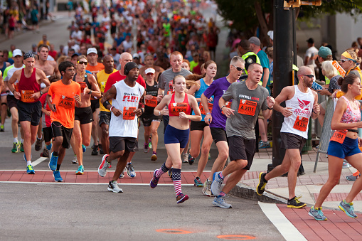 Atlanta, GA, USA - July 4, 2014:  Thousands of runners run down Peachtree Street on their way to the finish line of the Peachtree Road Race in Atlanta.