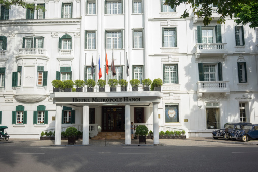 Ha Noi, Viet Nam - September 7, 2014: External front view of Hotel Sofitel Legend Metropole Hanoi with an old car. Sofitel Legend Metropole Hanoi is a well-known French architecture in Vietnam.