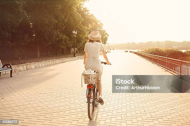 Girl Riding A Bicycle In Park Near The Lake Stock Photo - Download Image Now - Adult, Beautiful People, Beautiful Woman