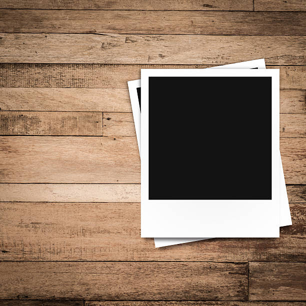 istock blank photo frames on brown wood texture background 512862897