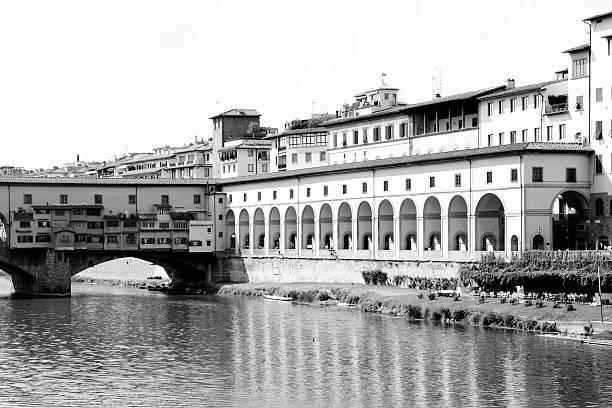 Couple kissing at sunset in front of Ponte Vecchio Florence