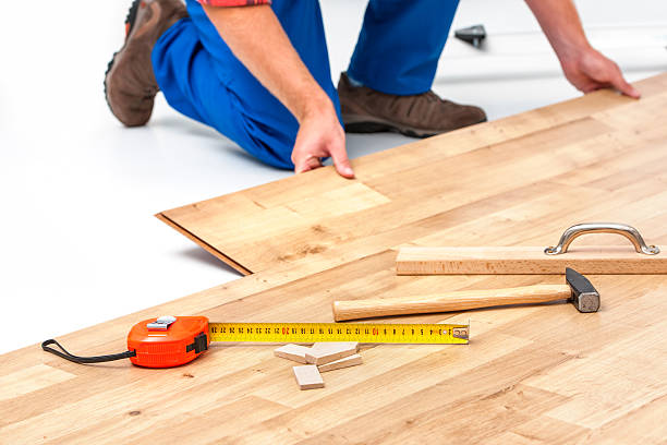 Man laying laminate flooring carpenter worker installing laminate flooring in the room parquet floor photos stock pictures, royalty-free photos & images