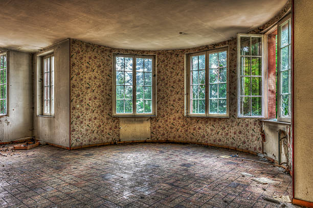 Dilapidated living room in an abandoned house stock photo