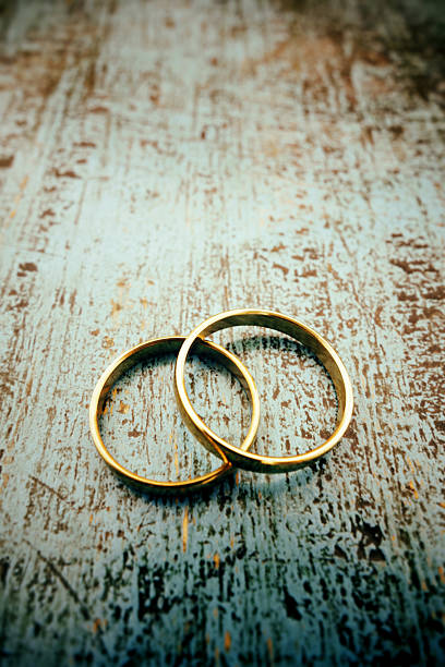 istock Gold rings on blue wood 512866467