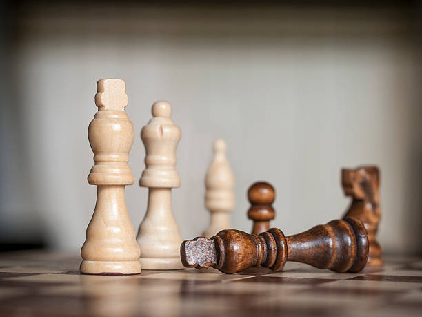 istock Wooden Chess Figures With The Black King Surrendering 512881440