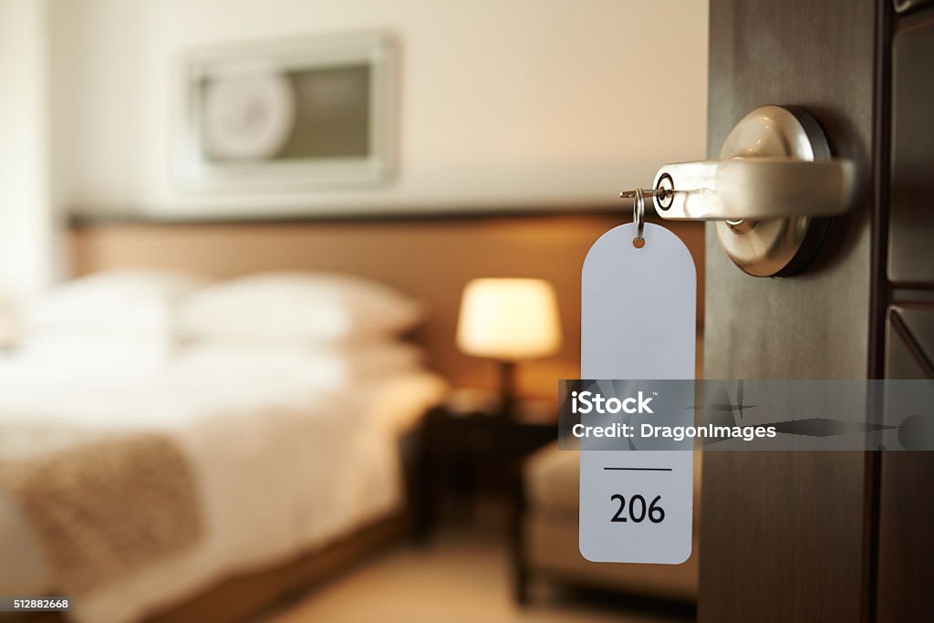 Entering hotel room Opened door of hotel room with key in the lock Hotel Stock Photo