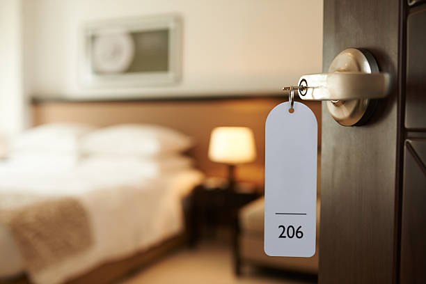 Entering hotel room Opened door of hotel room with key in the lock hotel stock pictures, royalty-free photos & images