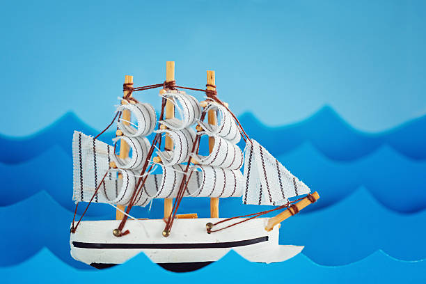 istock White Ship on blue wave with paper and sun. 512883736
