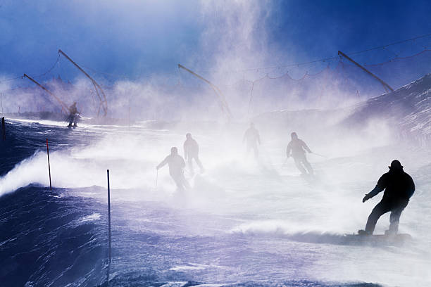 istock Silhouettes of skiers going down the mountain 512884022