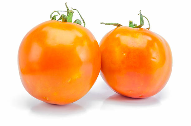 istock fresh red-yellow tomato on white background. 512884146