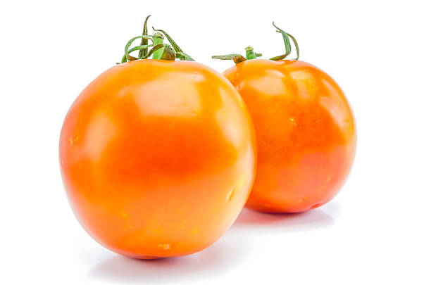 istock fresh red-yellow tomato on white background. 512884186