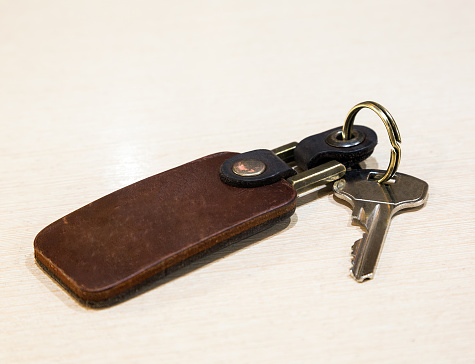 rectangular key ring with a key ring, leather, key, closeup
