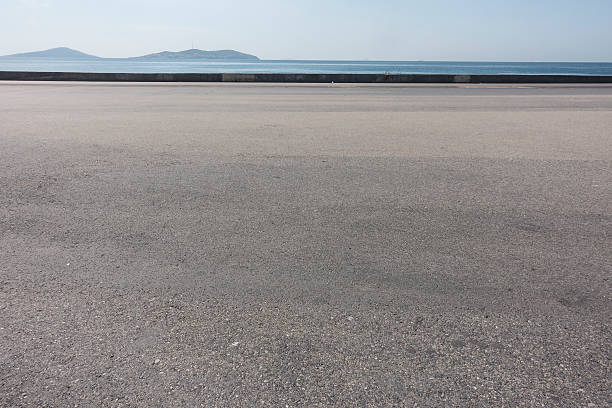 asphalte rez-de-chaussée avec fond de l'espace en bord de mer - macadam photos et images de collection