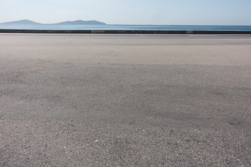 asphalt ground space with seaside background