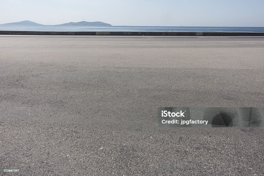 asphalt ground space with seaside background Asphalt Stock Photo
