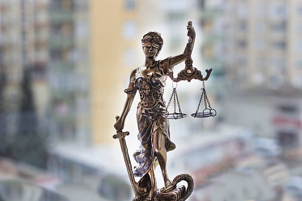 Justice statue with sword and scale. Law concept stock photo