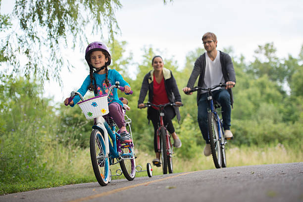 istock Family Riding Bikes on a Trail 512887424