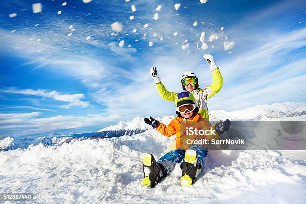 Mother And Son On The Mountain Happy Throw Snow Stock Photo - Download Image Now - Skiing, Child, Snow