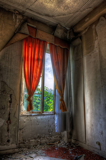 Desolate window in an abandoned house stock photo