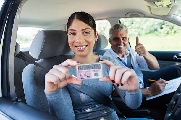 istock woman holding driver's license 512887984