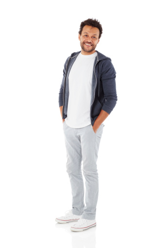 Full length image of attractive mature man in casuals looking at camera while standing with his hands in pocket on white background
