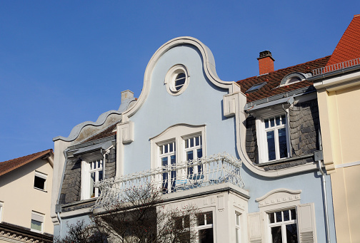 Dormer and balcony of a light blue classic townhouse, art nouveau, Karlsruhe (Germany).