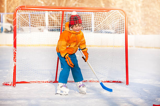 istock Little boy goalkeeper play ice hockey 512889464