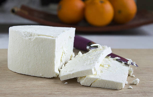 White feta cheese Feta cheese on a wooden cutting board feta cheese block stock pictures, royalty-free photos & images