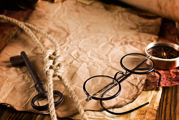 istock Compass, rope and glasses on old paper 512890087