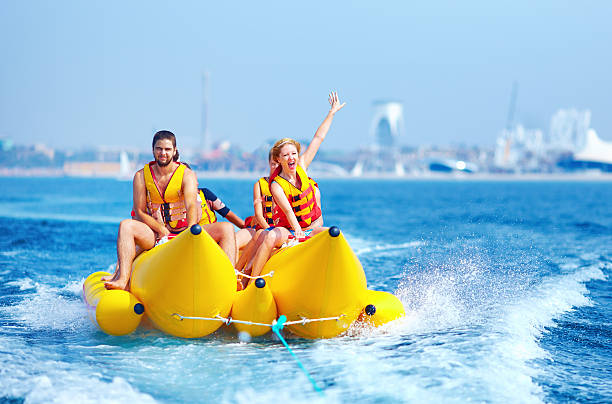 istock happy people having fun on banana boat 512890241
