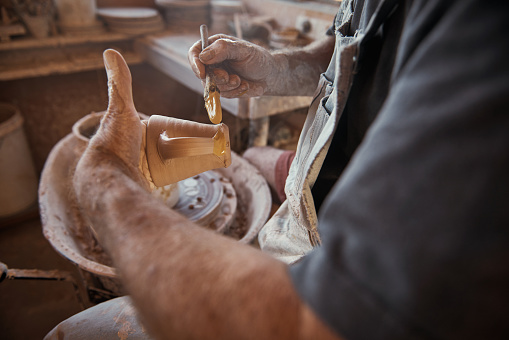 Cropped shot of a craftsman working on his pottery in his workshopimage806442.jpg