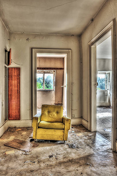 Yellow armchair in an abandoned house stock photo