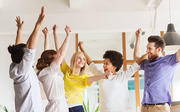 istock happy creative team celebrating victory in office 512891174