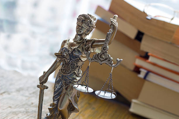 istock Justice statue with sword and scale and books. Law concept 512891200
