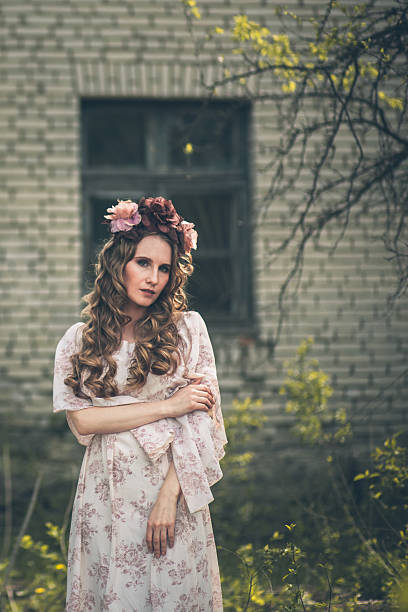 istock Young pretty girl is posing with flowers 512891765