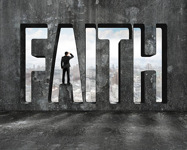 istock Faith word on concrete wall with man gazing on view 512892272
