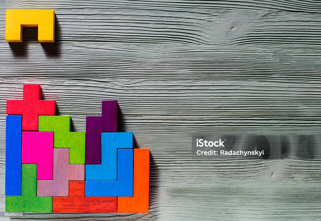 Geometric shapes on a wooden background. The concept of logical thinking. Geometric shapes on a wooden background.  game toy wooden blocks. Concepts Stock Photo