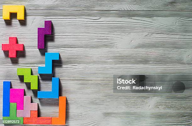 Geometric Shapes On A Wooden Background Stock Photo - Download Image Now - Toy Block, Block Stacking Video Game, Puzzle