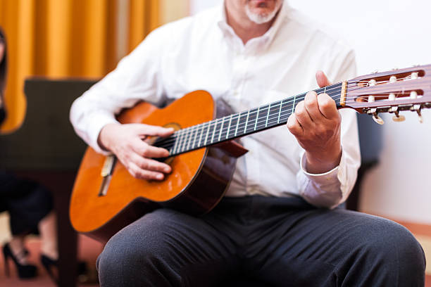 istock Man playing an acoustic guitar 512892735
