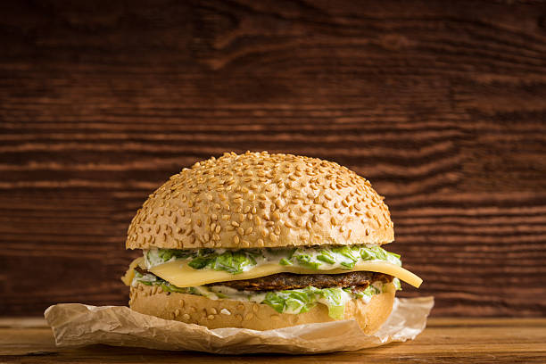 istock Burger on the wooden background 512892866