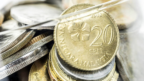 istock Malaysia gold coins in transparent hourglass.  Selective focus. 512893021